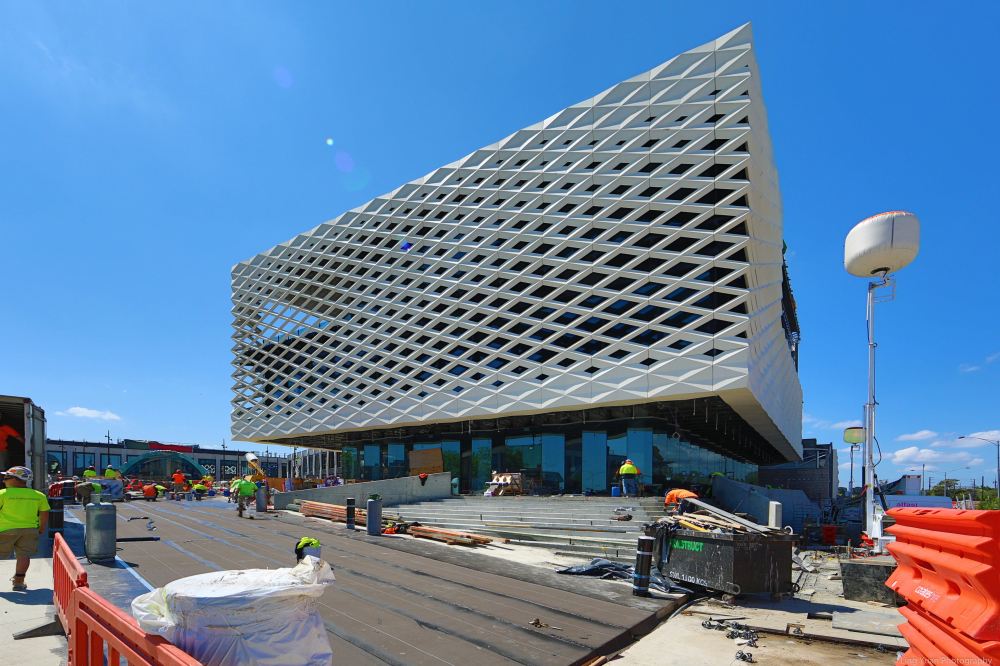 A lattice metal facade around a cube shaped building.