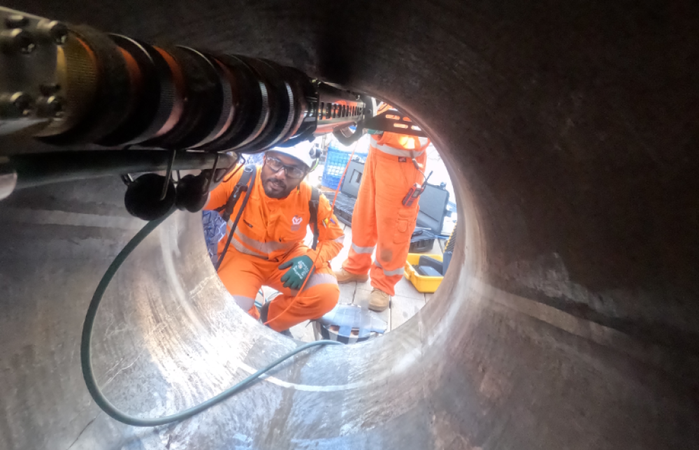 Team inspecting pipes