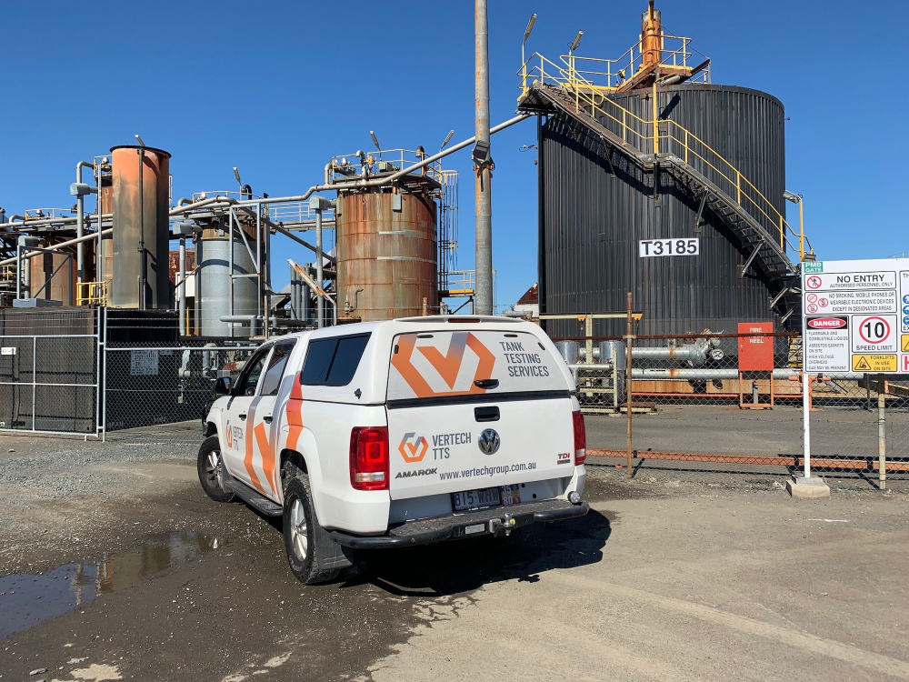 Vertech & Tank Testing van next to tanks